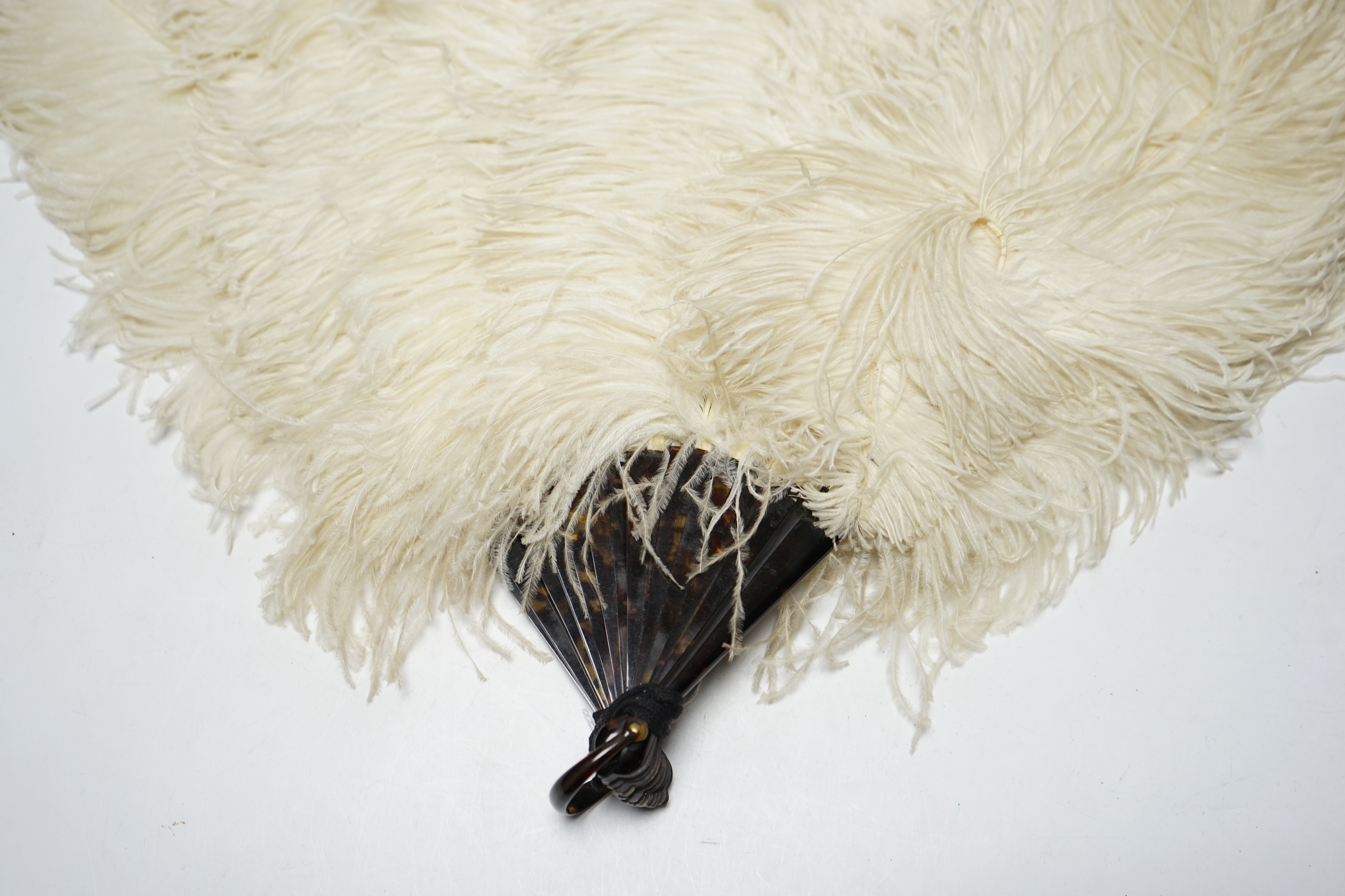 A 1930's boxed French cream Ostrich feather fan with tortoiseshell guards